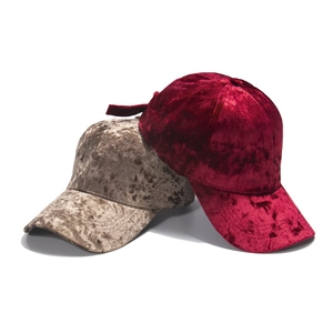 Detail of velvet texture on burgundy and champagne baseball caps with adjustable straps