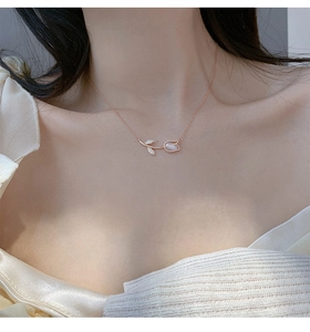 Close-up of elegant rose gold tulip pendant necklace with shimmering inlay on a model