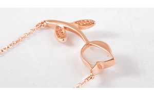 Close-up of rose gold flower pendant necklace featuring elegant hollow petal design