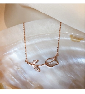 Close-up of rose gold tulip pendant with clear crystal and pave diamond leaves