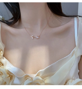 Rose gold tulip pendant necklace with cat-eye stone and diamonds on model neck