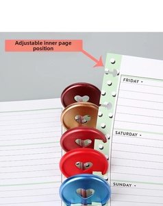 Macro view of heart-shaped plastic binding discs and mushroom hole loose-leaf notebook pages
