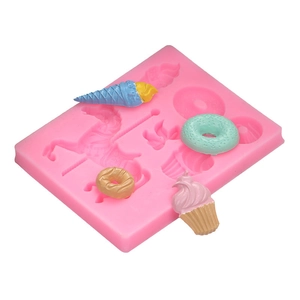 Pink silicone mold featuring carousel, ice cream, and donut shapes for cake decorating