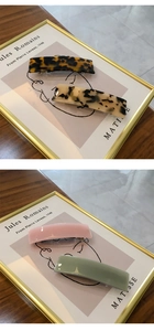 Close-up of elegant acetate spring hair clips in tortoiseshell and pastel colors