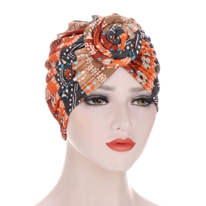 Detailed view of bohemian turban with spiral rose knot and geometric patterns