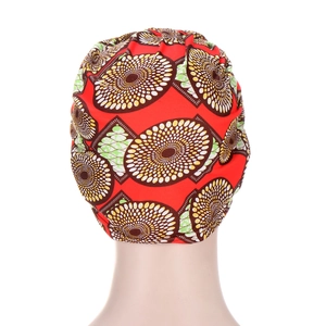 African style red headscarf hat with colorful spiral batik prints and ruched design