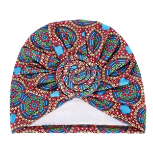 Detail of bohemian printed turban hat with a 3D spiral rose knot and ethnic pattern
