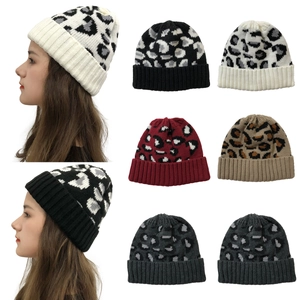 Detailed grid of leopard print knitted beanies in various colors with model wear