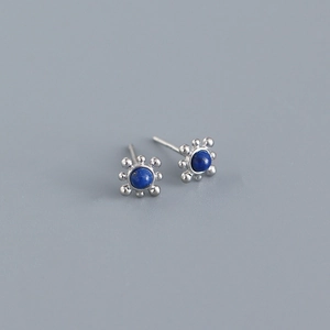 Detailed shot of S925 silver stud earrings featuring round lapis lazuli in floral setting