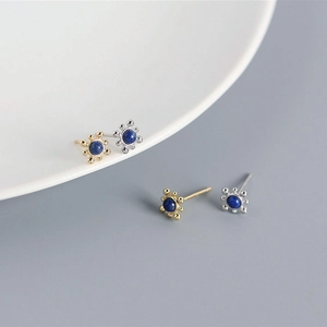 Detailed view of S925 silver stud earrings with sunburst design and lapis lazuli stones
