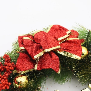 Close-up of red glitter bow and green pine needles on 40cm Christmas wreath