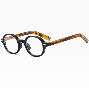 Detail of round black frame glasses with tortoiseshell temples and blue light lenses