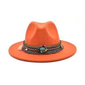 Detail of orange wool fedora featuring ethnic woven band with turquoise and tassels