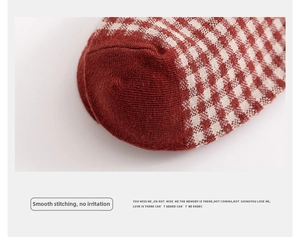 Macro shot of red plaid cotton socks showing the seamless toe and fine knit texture