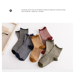 Flat lay of five pairs of vintage gingham cotton crew socks with rolled cuffs and diverse colors