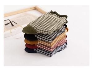 Detailed knit texture of vintage plaid cotton socks with rolled edge and checkerboard pattern