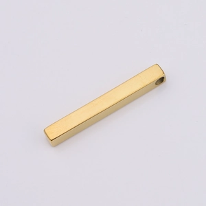 Macro view of a gold rectangular stainless steel bar pendant with mirror finish and hole