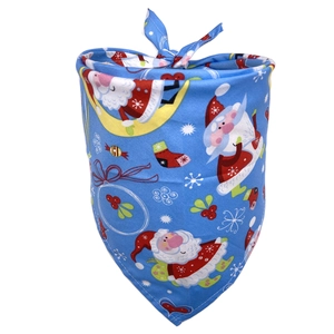 Detail showing blue Christmas dog bandana with Santa and snowflake festive patterns