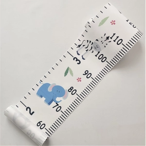 Detail of wooden hanging ruler for kids showing elephant zebra patterns and canvas texture