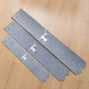 Gray felt Christmas tree skirt base featuring white reindeer patterns for festive decor