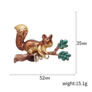 Creative squirrel enamel brooch pin with brown acorn and green leaves on white background