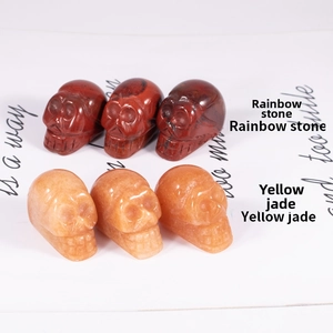 Set of hand-carved skull figurines in natural polished rainbow stone and yellow jade