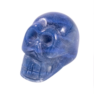 Blue natural stone skull carving with polished crystal texture on a white background