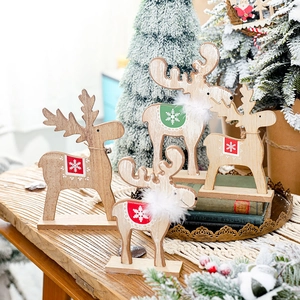 Wooden Christmas reindeer table ornaments with festive decor on warm wooden surface