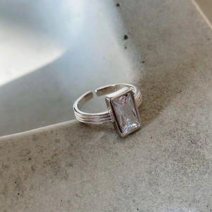 Macro shot of 925 sterling silver ring featuring a rectangle zircon on tiered band