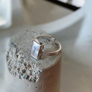 Macro side view of an adjustable 925 silver ring featuring a rectangular zircon stone