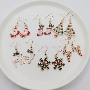 Close-up of six pairs of festive Christmas hook earrings featuring Santa and reindeer
