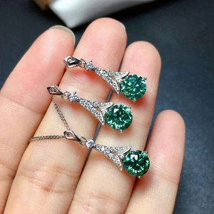 Three-piece jewelry set with green moissanite pendant and earrings in silver finish