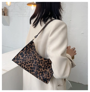 Fashionable leopard print underarm bag shown with a beige blazer for a stylish look