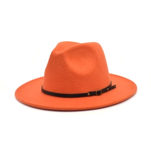 Detailed close-up of orange wool fedora hat with black leather band and gold buckle