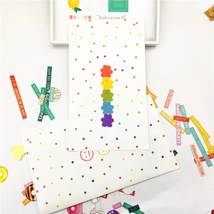 Flat lay of colorful rainbow bear stationery set with motivational English stickers