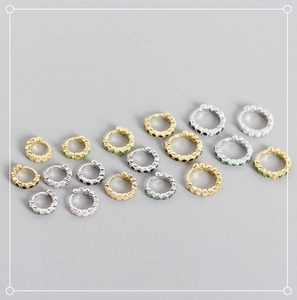 Macro shot of S925 silver huggie earrings with colorful zircon stones in various color sets