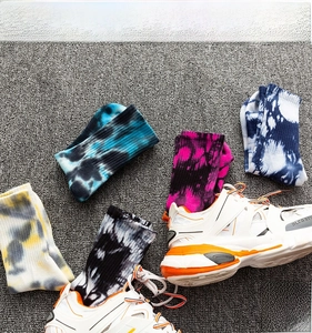 Detailed view of colorful tie-dye cotton socks paired with chunky platform sneakers