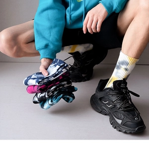 Close-up of crew tie-dye cotton sports socks with colorful patterns and cushioned texture