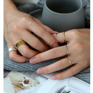 Set of gold and silver plated adjustable minimalist rings shown on a hand model