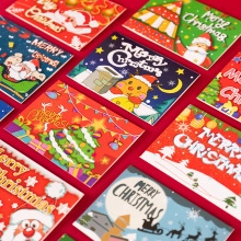 Flat lay of 3D Christmas greeting cards with Santa and tree motifs on red background