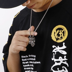 Mens stainless steel twisted chain necklace with a bearded skull pendant on a model
