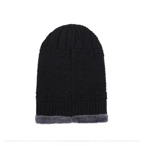 Detail of the thick grey fleece lining and knit texture of the black winter beanie