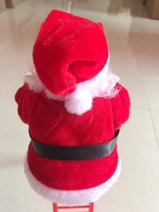 Detail of red plush Santa Claus climbing ladder toy showing textile texture and back view