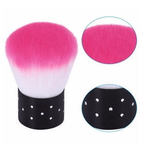 Detail of pink and white nail dust brush featuring a black handle with silver rhinestones