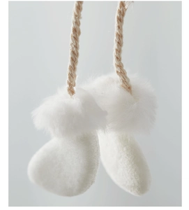 Macro shot of white plush Christmas angel pendant with soft texture and woven lanyard
