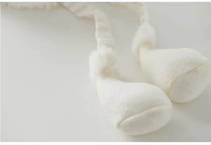 Close-up of white plush fabric and soft knitted texture on the Christmas angel doll decoration