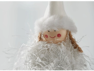 Macro shot of white plush Christmas angel doll with braided hair and soft fabric texture