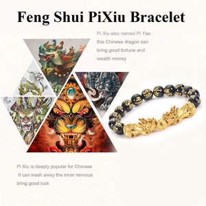 Detailed view of Pi Xiu bracelet with black beads and engraved golden mantra symbols