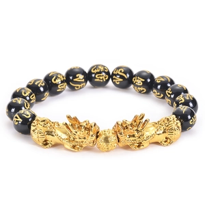 Detail of black obsidian beads with golden mantra and double Pixiu charms