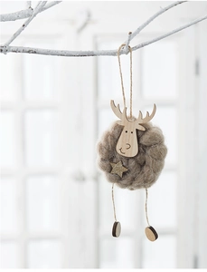 Detail of wool felt reindeer ornament with wooden base hanging on a white branch